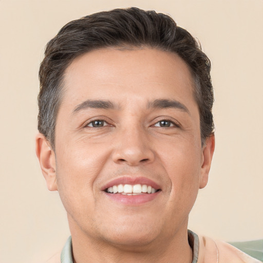 Joyful white adult male with short  brown hair and brown eyes