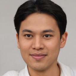 Joyful asian young-adult male with short  brown hair and brown eyes