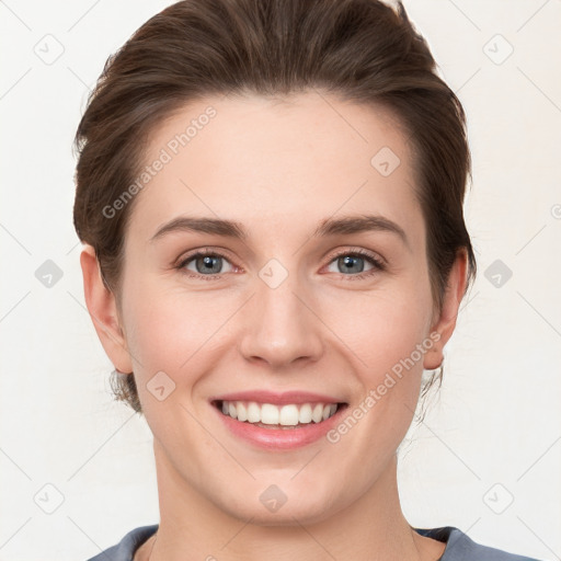 Joyful white young-adult female with short  brown hair and grey eyes