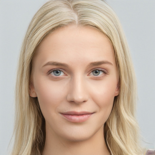 Joyful white young-adult female with long  brown hair and blue eyes