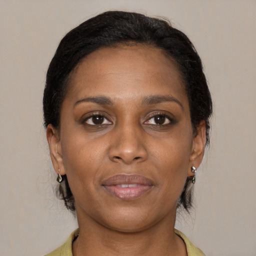 Joyful black young-adult female with medium  brown hair and brown eyes