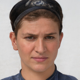 Joyful white young-adult male with short  brown hair and blue eyes