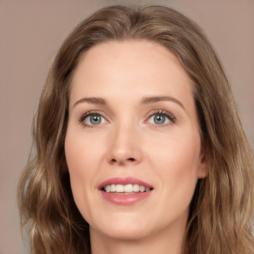 Joyful white young-adult female with medium  brown hair and green eyes