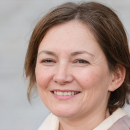 Joyful white adult female with medium  brown hair and brown eyes