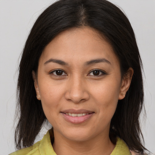 Joyful asian young-adult female with medium  brown hair and brown eyes