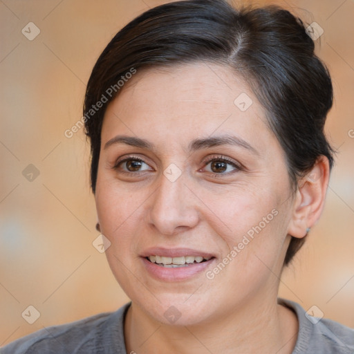 Joyful white adult female with medium  brown hair and brown eyes