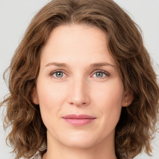 Joyful white young-adult female with medium  brown hair and green eyes