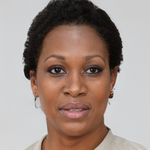 Joyful black young-adult female with short  brown hair and brown eyes