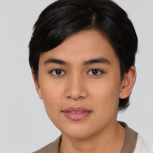 Joyful latino young-adult female with short  brown hair and brown eyes