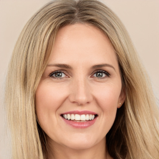 Joyful white young-adult female with long  brown hair and green eyes