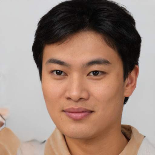 Joyful asian young-adult male with short  brown hair and brown eyes
