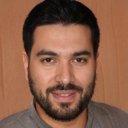 Joyful white young-adult male with short  black hair and brown eyes