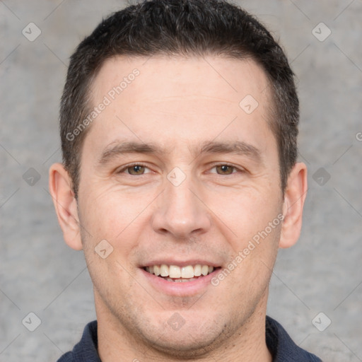 Joyful white adult male with short  brown hair and brown eyes