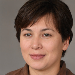 Joyful white adult female with medium  brown hair and brown eyes