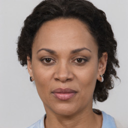 Joyful black adult female with short  brown hair and brown eyes