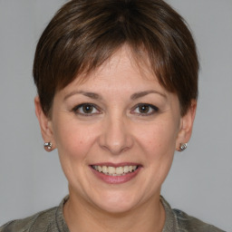 Joyful white young-adult female with medium  brown hair and grey eyes