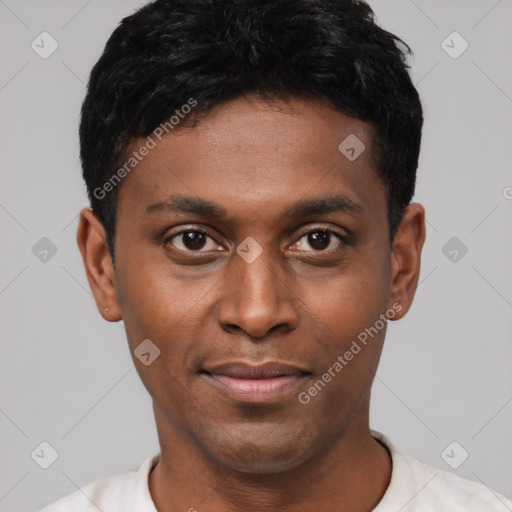 Joyful black young-adult male with short  black hair and brown eyes