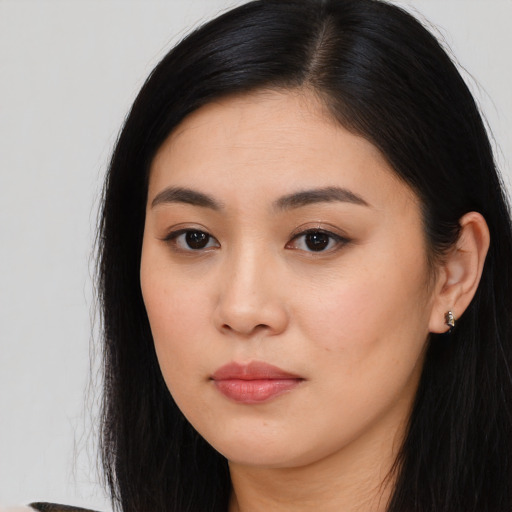 Joyful asian young-adult female with long  black hair and brown eyes