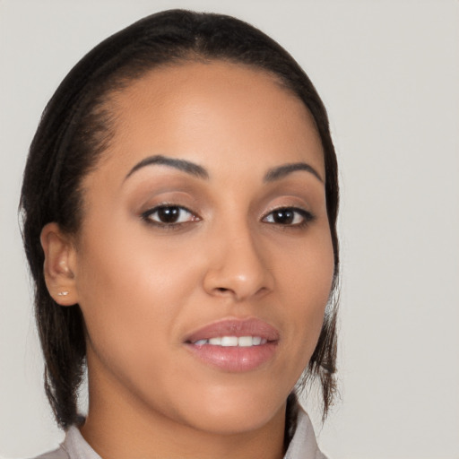 Joyful latino young-adult female with medium  brown hair and brown eyes