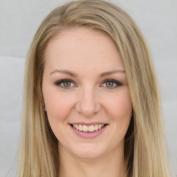 Joyful white young-adult female with long  brown hair and green eyes