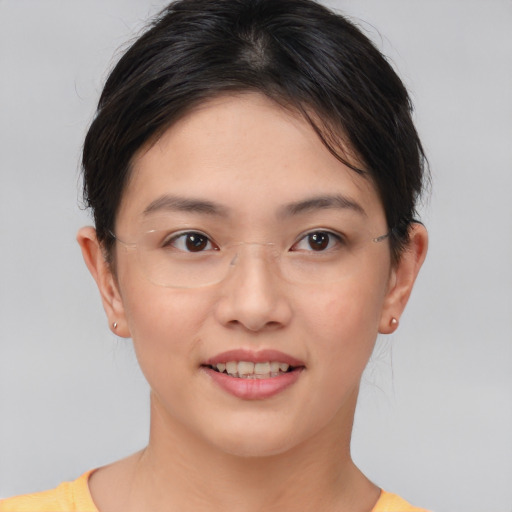 Joyful asian young-adult female with short  brown hair and brown eyes