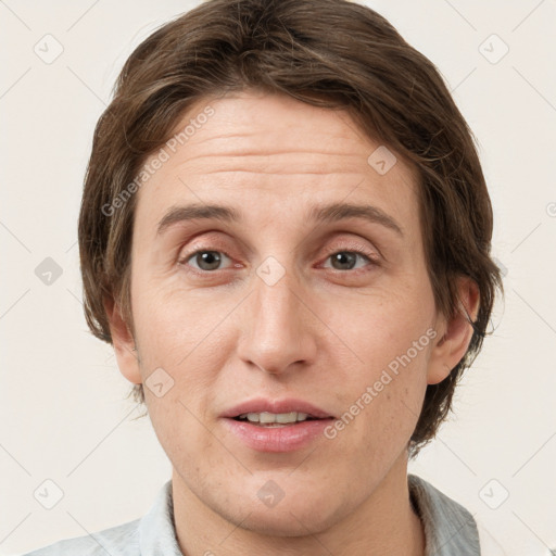 Joyful white adult female with medium  brown hair and grey eyes