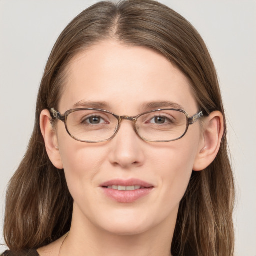 Joyful white adult female with long  brown hair and grey eyes