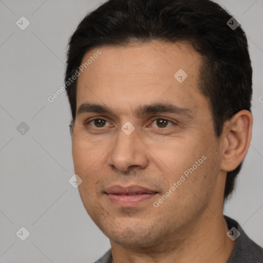 Joyful white adult male with short  black hair and brown eyes