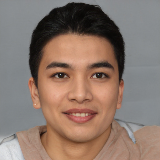 Joyful asian young-adult male with short  brown hair and brown eyes