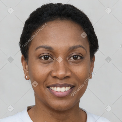 Joyful black young-adult female with short  brown hair and brown eyes