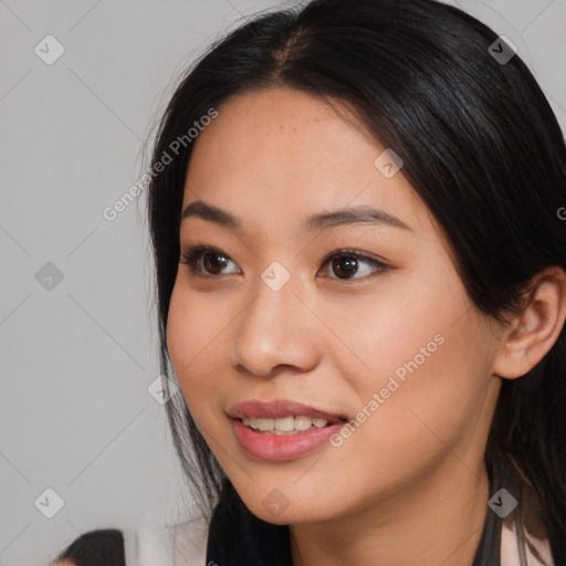 Joyful asian young-adult female with long  brown hair and brown eyes