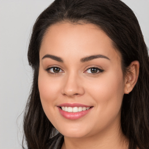 Joyful white young-adult female with long  brown hair and brown eyes