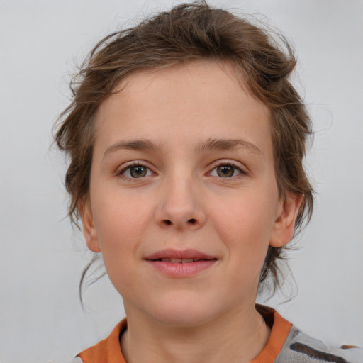 Joyful white child female with medium  brown hair and grey eyes