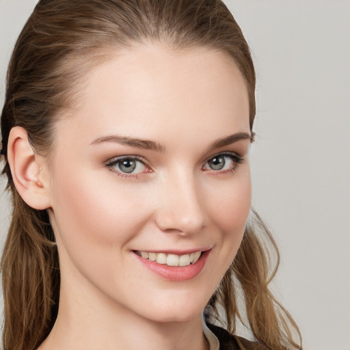 Joyful white young-adult female with long  brown hair and blue eyes