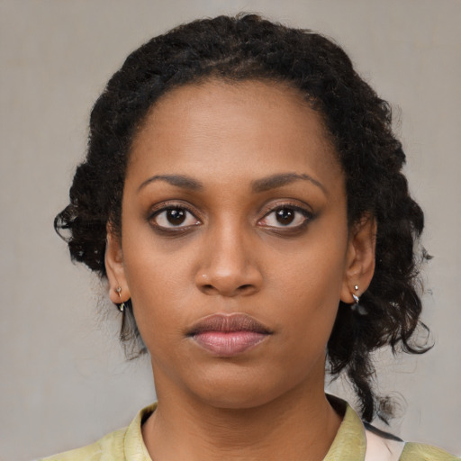 Neutral black young-adult female with medium  brown hair and brown eyes