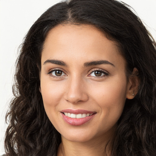 Joyful white young-adult female with long  brown hair and brown eyes