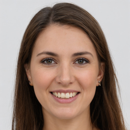 Joyful white young-adult female with long  brown hair and grey eyes