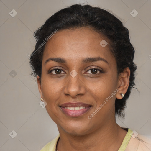 Joyful black adult female with short  brown hair and brown eyes