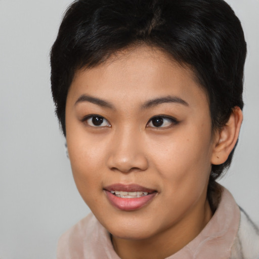 Joyful asian young-adult female with short  brown hair and brown eyes