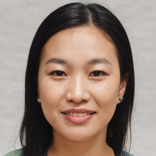 Joyful asian young-adult female with long  brown hair and brown eyes