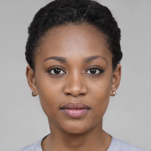 Joyful black young-adult female with short  black hair and brown eyes