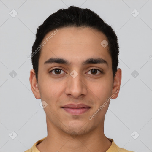 Joyful latino young-adult male with short  black hair and brown eyes