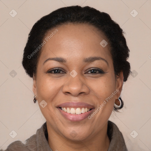 Joyful black adult female with short  brown hair and brown eyes