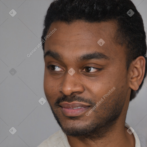 Joyful black young-adult male with short  black hair and brown eyes