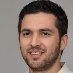 Joyful white young-adult male with short  black hair and brown eyes