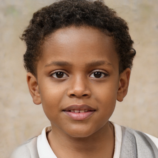 Joyful black child male with short  brown hair and brown eyes