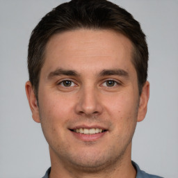 Joyful white young-adult male with short  brown hair and brown eyes