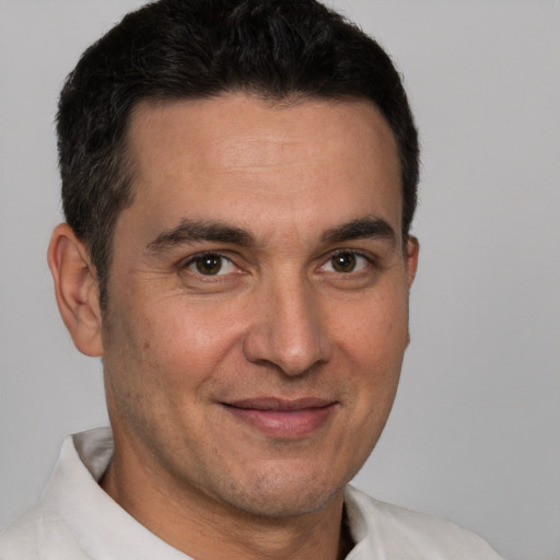 Joyful white adult male with short  brown hair and brown eyes