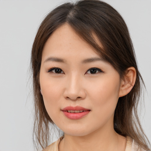 Joyful asian young-adult female with medium  brown hair and brown eyes