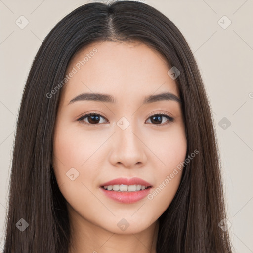 Joyful asian young-adult female with long  brown hair and brown eyes